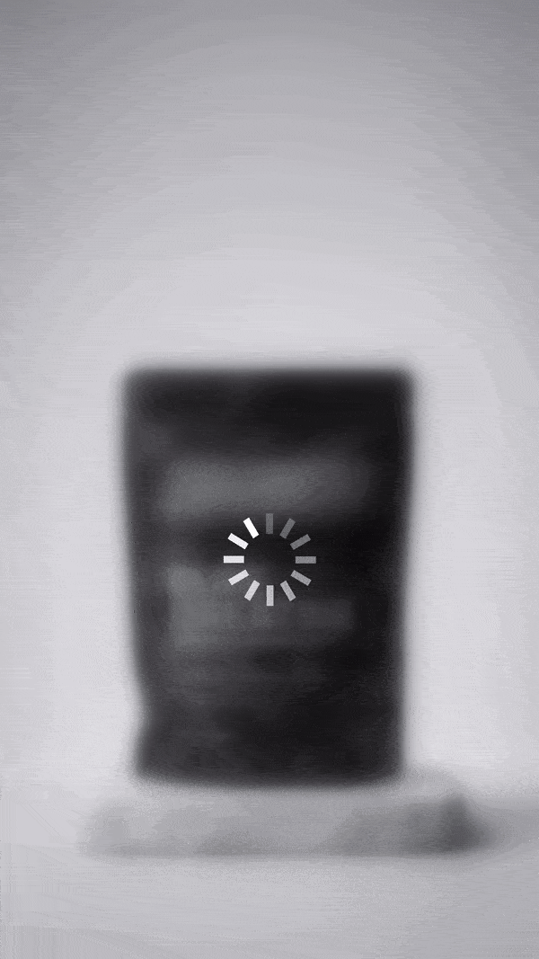 A blurred product on a plinth with a loading spinner. Text: Something is coming soon.